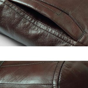 May include: Close-up of a brown leather jacket, showcasing the texture and stitching details. The image highlights a pocket and the seams, emphasizing the craftsmanship and material of the garment. The leather appears to have a slightly distressed finish.