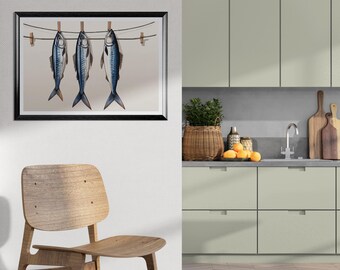 May include: A framed art print featuring three blue and silver fish hanging on a clothesline with wooden clothespins. The artwork is set against a light background, with a black frame. The image is a kitchen-themed wall art.