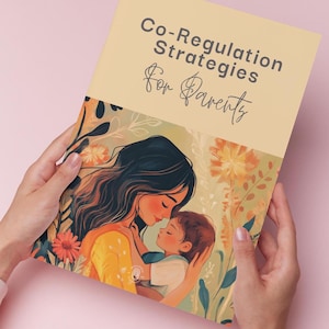 May include: A book titled "Co-Regulation Strategies for Parents" held by hands. The cover features an illustration of a mother and child embracing, surrounded by floral elements in shades of orange, yellow, and green. The background is a soft pink.