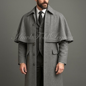 Puede incluir: Un abrigo largo de lana gris con una capa superpuesta, con cierre de botones y bolsillos con solapa. Debajo se ve un chaleco gris oscuro, una camisa blanca de cuello y una corbata negra. El texto Hawk Fold Legacy aparece centrado.