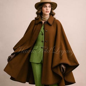May include: A brown wool cape with a collar and buttons worn over a light green blazer and matching trousers. The outfit includes a tan fedora hat, brown leather gloves, and brown ankle boots. The text Hawk Fold Legacy is visible in the center.