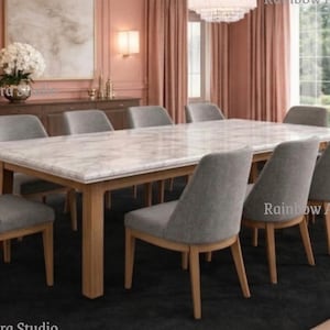 May include: A rectangular dining table with a marble effect top and wooden legs is surrounded by ten grey upholstered chairs. The table is on a black rug in a room with pink walls and curtains. A chandelier hangs above the table.