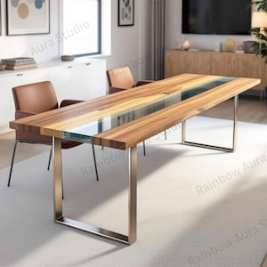May include: A rectangular wooden dining table with a clear, blue-tinted resin inlay running down the center. The table has a natural wood grain finish and is supported by brushed metal legs. The room features brown leather chairs and a neutral carpet.