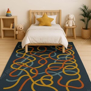May include: A navy blue rug with a colorful abstract design of intertwined lines in orange, yellow, and teal. The rug is placed in a child's bedroom, under a wooden bed with a star-shaped pillow.