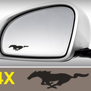 May include: A black silhouette of a running horse is displayed on a car side mirror. The mirror is silver and part of a car. Below the mirror is a brown background with a black horse silhouette and the text "4X" in yellow.