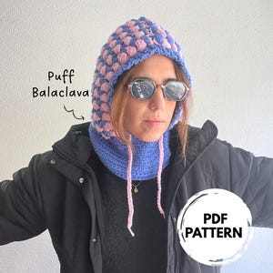 May include: A blue and pink puff balaclava with a matching neck warmer. The balaclava has a textured, bubble-like pattern. The text "PDF PATTERN" is in a white circle.