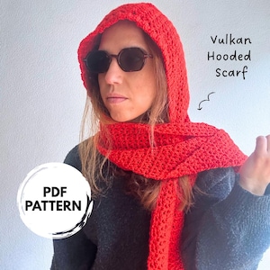 May include: A bright red crocheted hooded scarf with a textured stitch pattern. The text Vulkan Hooded Scarf is printed on the right side with a small arrow pointing to the scarf. A circular white graphic with the text PDF PATTERN is visible.