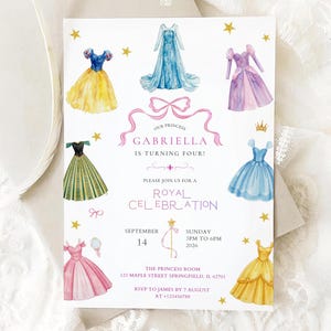 May include: A white invitation card featuring watercolour illustrations of princess dresses and gold stars. The text reads "Our Princess Gabriella is turning four!" and invites guests to a Royal Celebration.