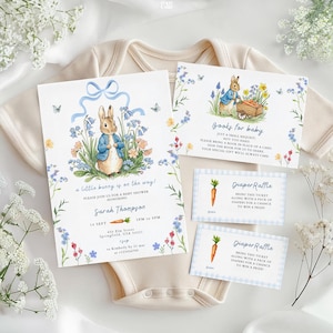 May include: Baby shower invitations and raffle tickets featuring a watercolor illustration of a bunny in a blue jacket. The invitation includes text: "a little bunny is on the way!" and "Books for baby". The diaper raffle tickets have a carrot graphic.
