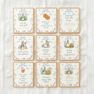 May include: Nine framed prints with a Peter Rabbit theme. Each print features illustrations of Peter Rabbit, floral accents, and text such as "Cards and gift" and "Baby's first library." The frames have a gold finish.