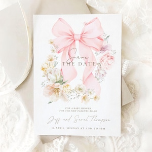 May include: A rectangular white card featuring a large, soft pink watercolor bow at the top center, surrounded by a floral arrangement of pale pink and cream flowers. The text reads: Save THE DATE, FOR A BABY SHOWER, FOR THE NEW PARENTS-TO-BE, Jeff and Sarah Thompson, 16 APRIL, SUNDAY AT 5 PM TO 8 PM.