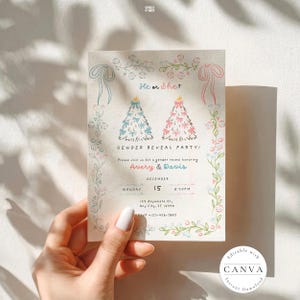 Beautifully designed gender reveal party invitation held by a hand with white nail polish, featuring a delicate design in blue and pink themes. It reads "He or She?" with two Christmas trees adorned with blue and pink bows. The invitation details the event for Avery & Davis on December 15 at 8:30 PM, with RSVP info included. A Canva watermark indicates it's an editable template. 🎉🎄✨