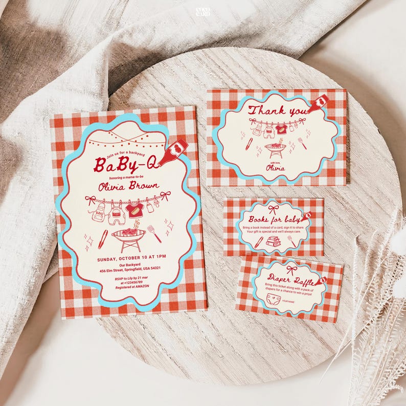 Baby-Q shower invitation suite on white wooden board over linen fabric. Red gingham cards with turquoise scalloped borders include main invitation for Olivia Brown (Sunday October 10, 1PM, 456 Elm Street Springfield), thank you card, books for baby request, and diaper raffle card. Features clothesline with baby items and BBQ grill illustrations.
