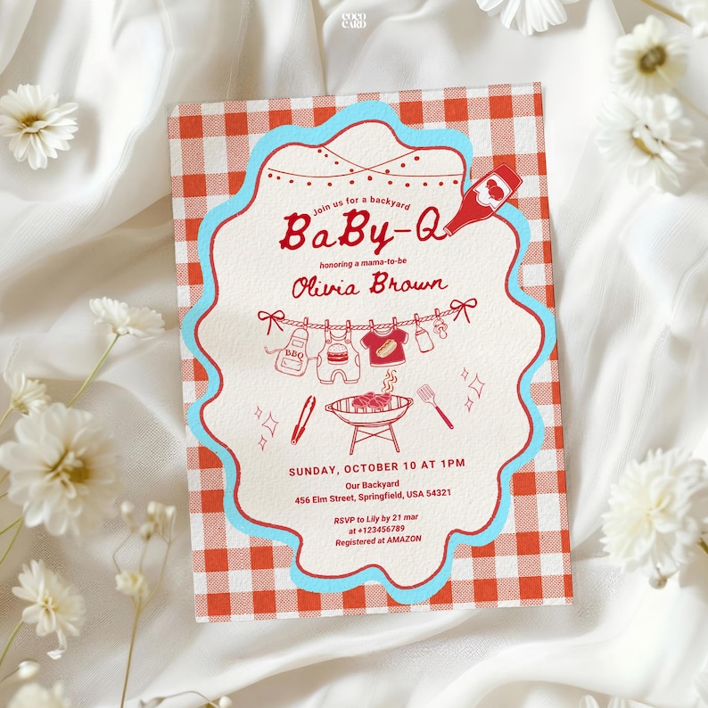 Baby-Q shower invitation with red gingham border and blue scalloped edge, displayed on white fabric with daisy flowers. Features string lights, clothesline with baby items, and BBQ grill illustration. Invites guests to honor Olivia Brown on Sunday October 10 at 1PM, 456 Elm Street Springfield. RSVP to Lily by March 21. Registry at Amazon.
