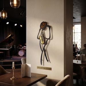 May include: A wall-mounted metal art piece depicting a stylized figure playing a gold saxophone, featuring a brown hat and black outline. Below the figure, a rectangular plaque displays the text THE BLUE NOTE LOUNGE - SAX PLAYER.