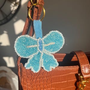 Blue embroidered bow bag charm