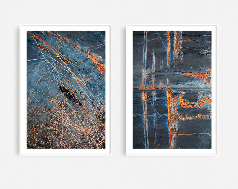 May include: Two abstract art prints featuring close-up images of rusty metal surfaces with blue, orange, and white tones.