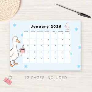 May include: A light blue 2026 calendar with a cartoon goose illustration. The calendar features the month of January with dates and days of the week. The text "12 PAGES INCLUDED" is at the bottom. A pen and paper clip are also visible.