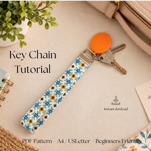 Könnte beinhalten: Ein Schlüsselanhänger aus Stoff mit blau-gelb-weißem geometrischem Fliesenmuster, silbernem Metallverschluss, orangefarbenem runden Anhänger und Metallschlüsseln. Der Text lautet Key Chain Tutorial, Instant download und PDF Pattern - A4 / USLetter - Beginners Friendly.