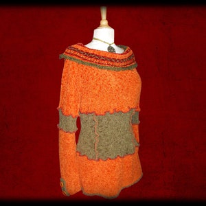 May include: Orange and brown knitted sweater with a crocheted collar and a ruffled hem.