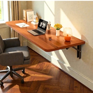 May include: A wall-mounted wooden desk with a laptop, stationery, and a small lamp. The desk is supported by black metal brackets. The laptop screen displays 8:31. A gray office chair sits in front of the desk. The desk is approximately 122 cm long.