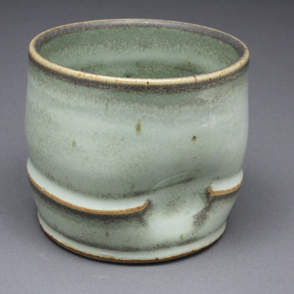 Ceramic tumbler with splotchy light green glaze