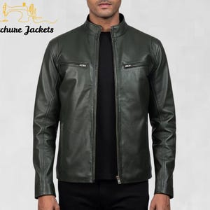 May include: A dark green leather jacket with a stand-up collar and two zippered chest pockets. The jacket has a full-length zipper closure and long sleeves. The brand name "Stitchure Jackets" is printed in the upper left corner.