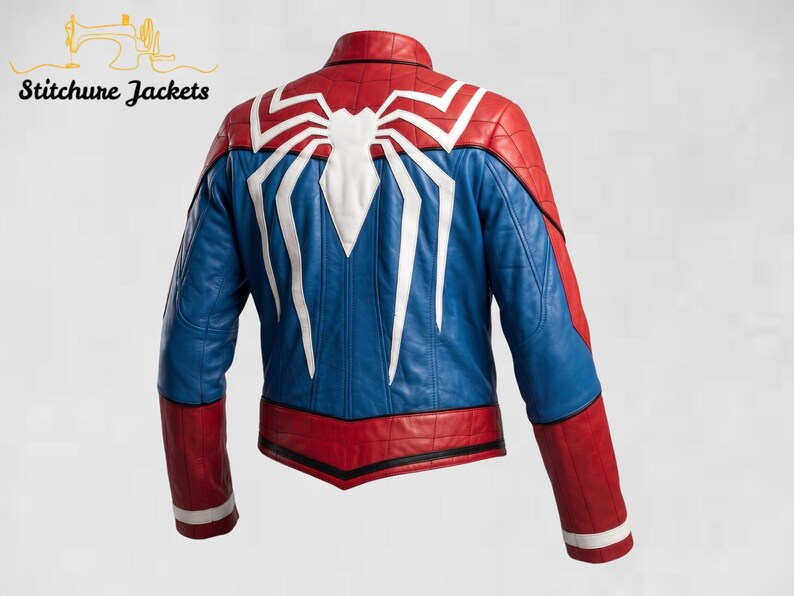 May include: A red and blue leather jacket featuring a large white spider emblem on the back. The jacket has a stand-up collar, long sleeves with red and white cuffs, and black piping details. The text Stitchure Jackets appears in the top left corner.