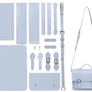 May include: A light blue leather satchel bag with a top handle and shoulder strap, alongside its individual cut pieces. The bag features two front buckles and a small front pocket. The pieces are laid out flat, demonstrating the bag's construction.