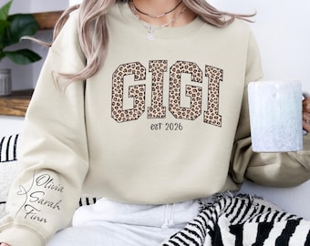 Custom Leopard Gigi Sweatshirt With Kid Name On Sleeve, Personalized Gigi Sweatshirt, Gift For Gigi, Christmas Gift Gigi Est 2026 Sweatshirt