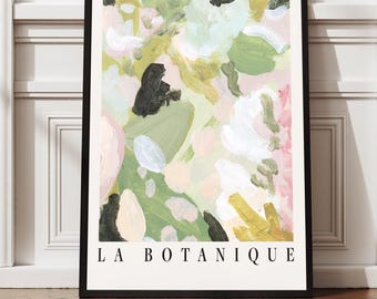 May include: Abstract art print in a black frame. The artwork features a colorful floral design with green, pink, yellow, and black brushstrokes. The text "LA BOTANIQUE" is printed in a serif font at the bottom of the print.