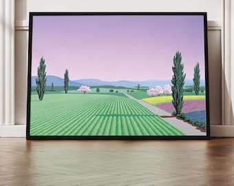 May include: A framed landscape art print featuring a field of green crops, a road, and trees under a purple sky. The artwork is displayed on a wooden floor against a white wall with a door.