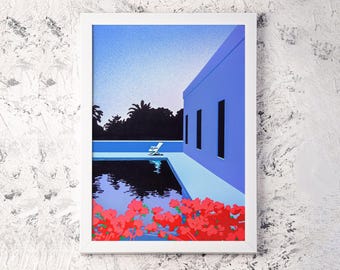 May include: A framed art print featuring a stylized illustration of a pool scene. The artwork depicts a blue building with dark windows, a pool with a white lounge chair, and red flowers. The sky transitions from light to dark blue.