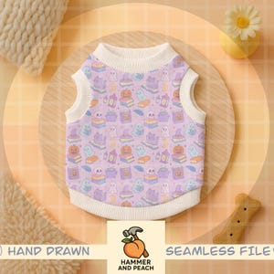 May include: A lavender dog shirt with a repeating pattern of Halloween-themed illustrations, including ghosts, pumpkins, books, and cats. The shirt has a white collar and armholes. The bottom right corner has a bone-shaped dog treat.