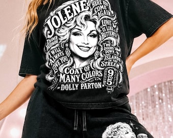 May include: A black t-shirt and matching shorts set featuring a white graphic print of Dolly Parton. The shirt displays her portrait surrounded by song titles including Jolene, 9 to 5, and I Will Always Love You. The shorts feature a similar graphic.