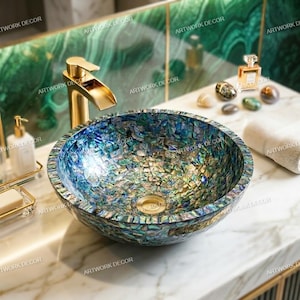 May include: A round vessel sink featuring a mosaic of iridescent blue and green abalone shell fragments. The sink includes a gold-toned drain and is paired with a matching gold-toned waterfall faucet, creating a reflective surface with varied textures.