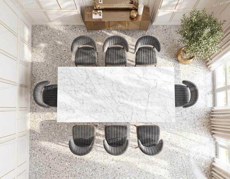 May include: A rectangular dining table with a white marble top featuring grey veining, surrounded by eight dark grey upholstered chairs with curved backrests, arranged in a symmetrical layout within a room with light-colored walls and flooring.
