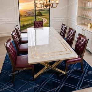 May include: A rectangular dining table with a light beige marble-effect top featuring gold-toned rectangular inlay lines and a gold-toned x-shaped metal base, surrounded by six high-backed chairs upholstered in deep burgundy tufted leather.