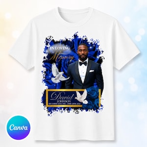 May include: A white t-shirt featuring a memorial graphic with a man in a black suit and bow tie, surrounded by blue roses and white doves. The text reads IN LOVING MEMORY, David JOHNSON, and the dates DECEMBER 12TH, 1986 - APRIL 20TH, 2025.