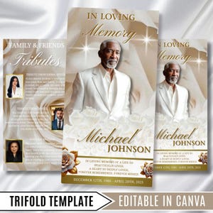 May include: A funeral program trifold template featuring a portrait of a man in a white suit, white roses, and gold text reading In Loving Memory, Michael Johnson, and dates December 12th, 1986 - April 20th, 2025, set against a soft white fabric background.