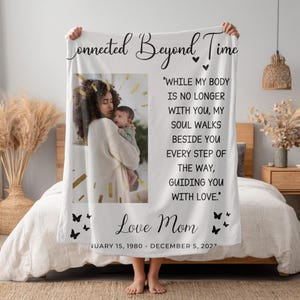 May include: White fleece blanket with a photo of a mother and child, gold confetti, and the text "Connected Beyond Time." Includes a quote and "Love Mom" with dates. Black butterfly accents.