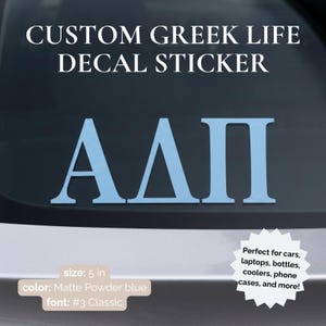 May include: A matte powder blue decal sticker featuring the Greek letters Alpha, Delta, and Pi. The sticker measures 5 inches in size and uses a classic font style. The text CUSTOM GREEK LIFE DECAL STICKER is displayed above the Greek letters.