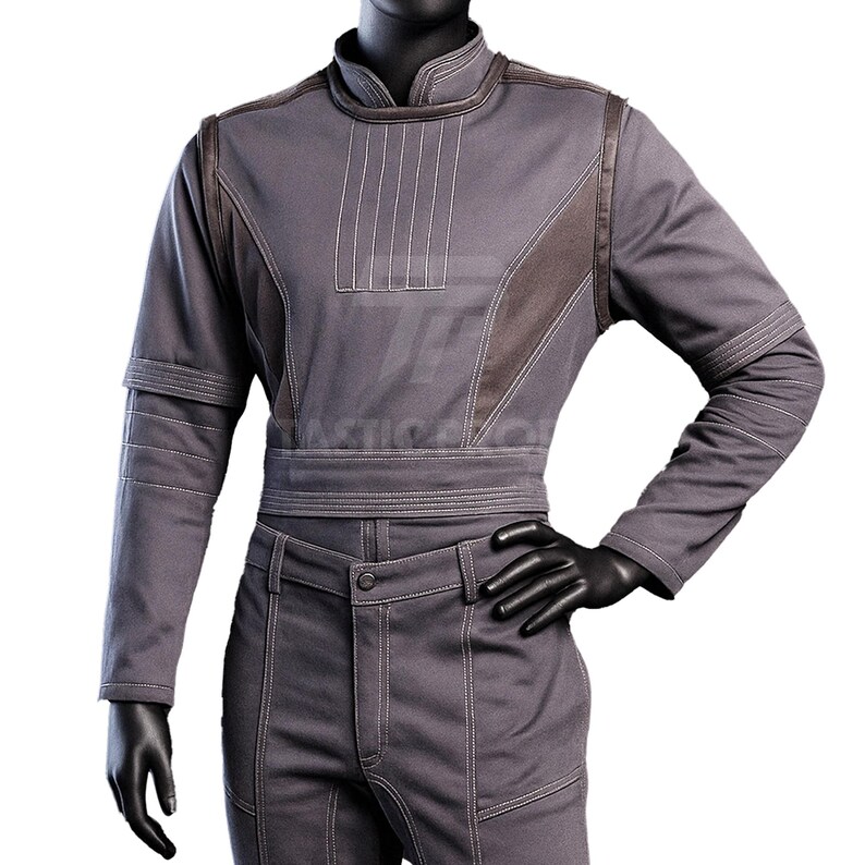 May include: A gray jumpsuit with a mandarin collar, long sleeves, and a matching belt. The outfit features white stitching details and brown accents on the shoulders and chest. The mannequin wears black gloves.