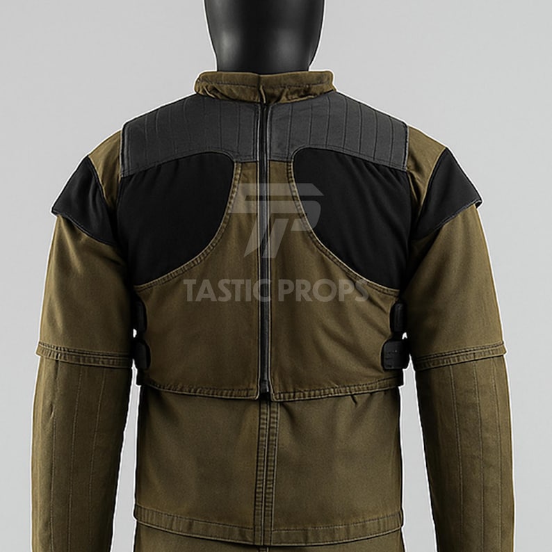 May include: Olive green jacket with black shoulder accents and a high collar. The jacket features a zipper closure and the text "TASTIC PROPS".