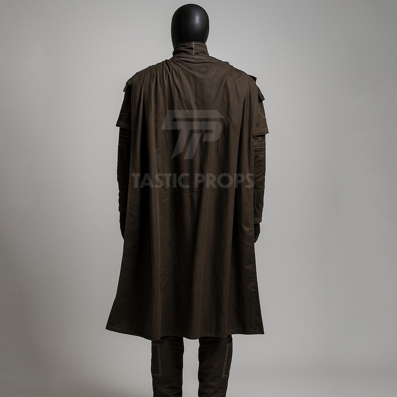 May include: A brown costume with a long cape and matching pants. The costume is displayed on a mannequin. The text "TASTIC PROPS" is printed on the cape.
