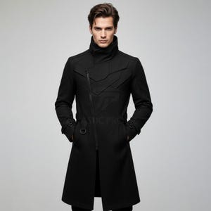May include: A black long coat featuring a high collar, an asymmetrical front zipper closure, and geometric paneling across the chest. The coat includes adjustable straps with metal D-ring hardware at the waist and cuffs, providing a structured fit.