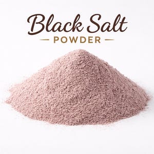 May include: A mound of pink-purple black salt powder on a white backdrop. The words "Black Salt - POWDER" are written in brown script above the pile. The powder has a fine, granular texture.