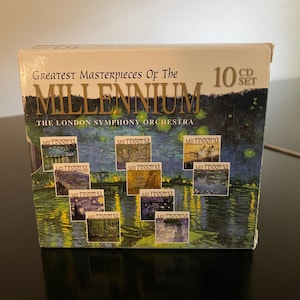 May include: A CD set titled "Greatest Masterpieces of the Millennium" by The London Symphony Orchestra. The box set features a landscape painting and includes 10 CDs. The box is white with gold lettering.
