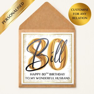 May include: A personalized 80th birthday card for Bill, featuring gold-colored numbers and text on a white background. The card is inside a brown envelope and includes the text "Happy 80th Birthday to my wonderful husband."