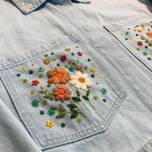 Hand-embroidered denim jacket – unique floral design, one-of-a-kind wearable art.